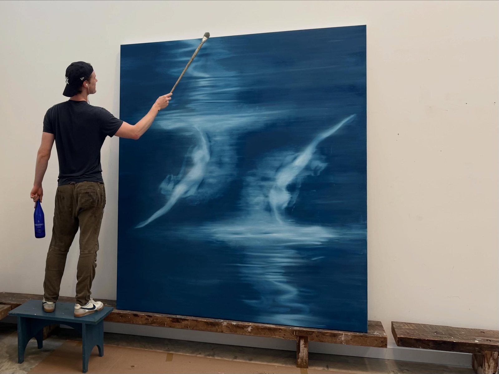 At work on a large blue canvas